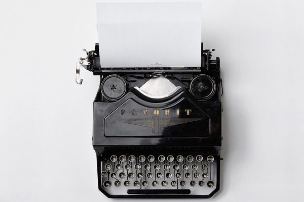 Maquina de escribir antigua sobre una mesa blanca. Hace referencia al marketing de contenidos.